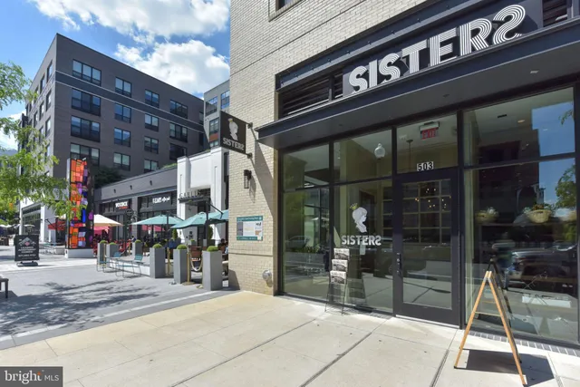 a living room with furniture and large windows