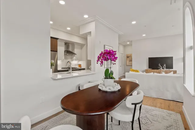 a view of a dining room with furniture and a potted plant