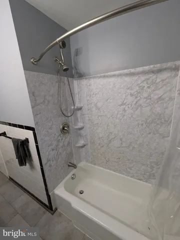 a bathroom with a shower and a bath tub