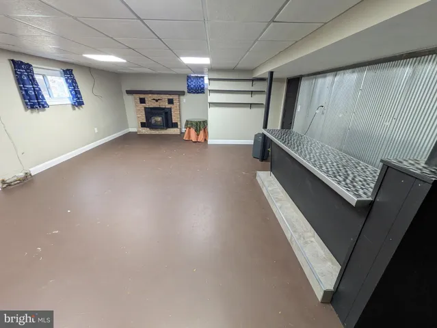 a view of an empty room with a fireplace