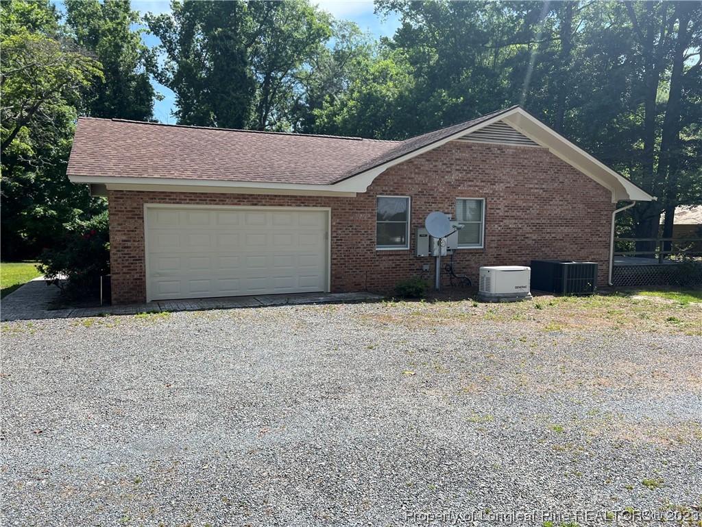 1997 Jenkins Road Fairmont, NC 28340 - Photo 2 of 47 a front view of a house with a yard and garage