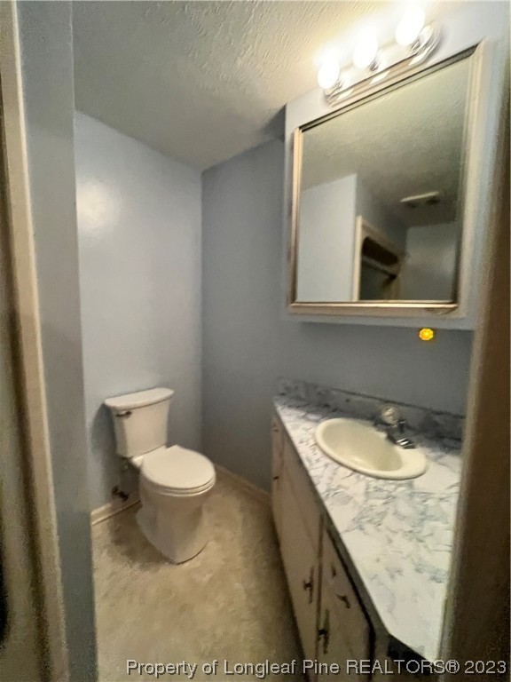 1997 Jenkins Road Fairmont, NC 28340 - Photo 30 of 47 a bathroom with a granite countertop sink a toilet and mirror