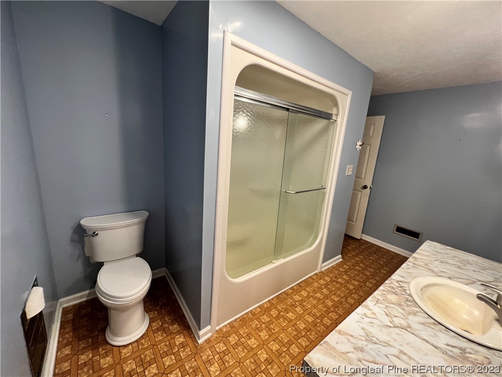 1997 Jenkins Road Fairmont, NC 28340 - Photo 36 of 47 a bathroom with a toilet and a mirror