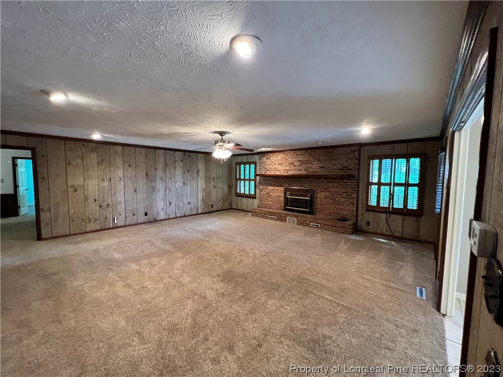 1997 Jenkins Road Fairmont, NC 28340 - Photo 10 of 47 an empty room with fireplace and windows
