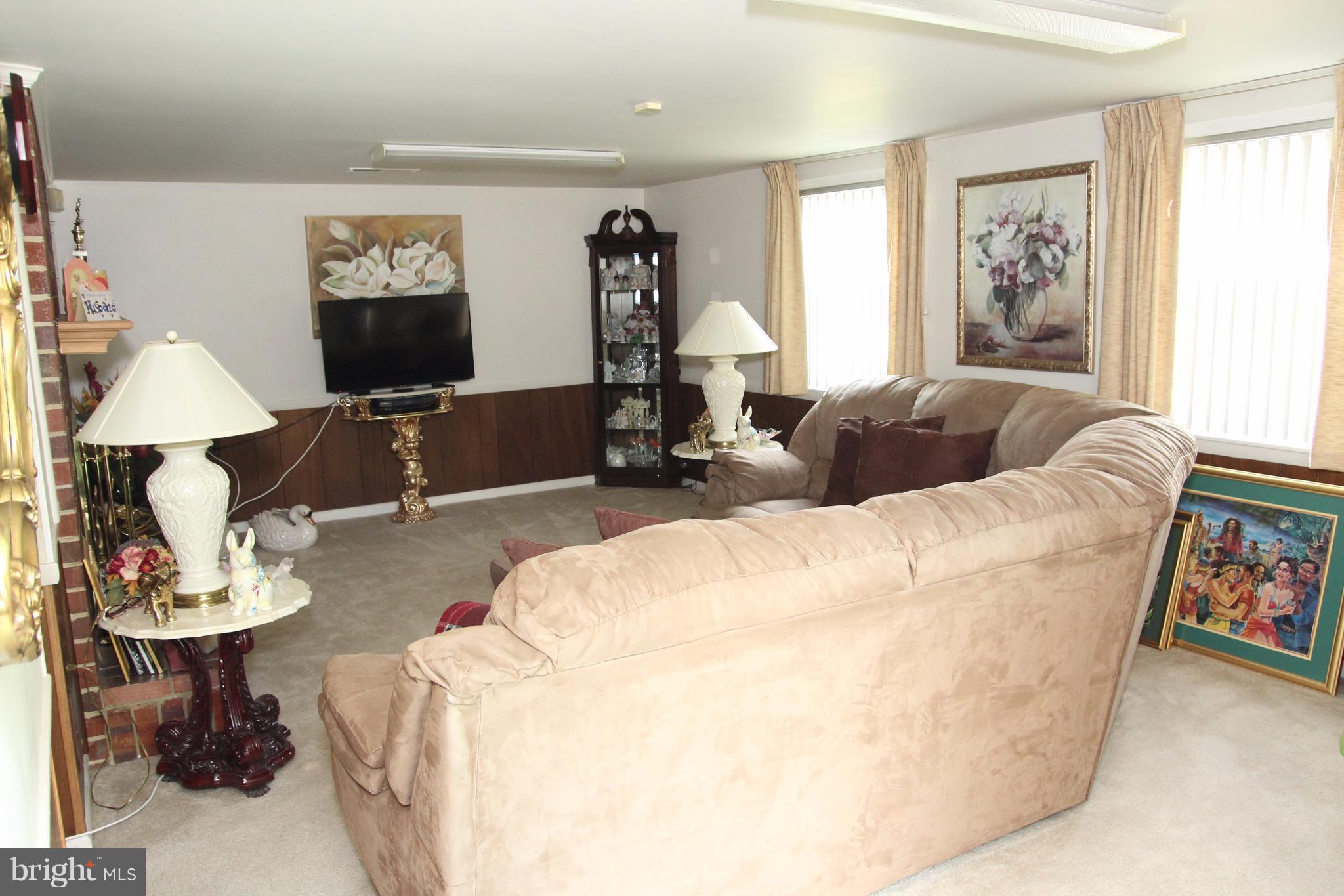 3413 Dunnington Road Beltsville, MD 20705 - Photo 13 of 16 a living room with furniture and a flat screen tv
