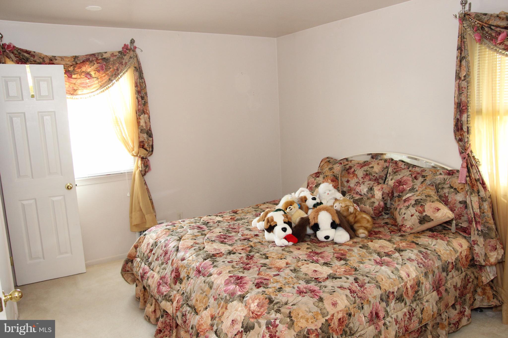 3413 Dunnington Road Beltsville, MD 20705 - Photo 6 of 16 a bedroom with a bed and a window