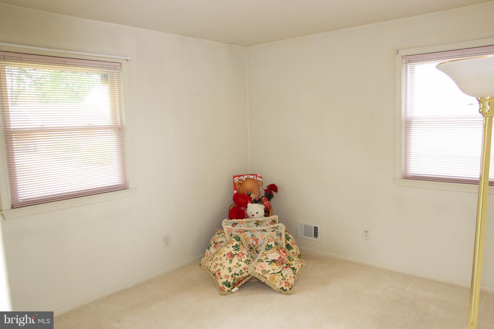 3413 Dunnington Road Beltsville, MD 20705 - Photo 9 of 16 a bedroom with a bed and window