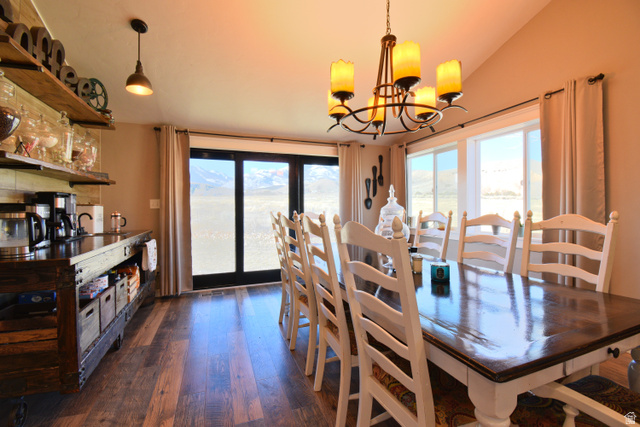 656 South Bullion Canyon Road Marysvale, UT 84750 - Photo 19 of 57 Dining area featuring healthy amount of natural light, dark wood finished floors, a chandelier, and lofted ceiling