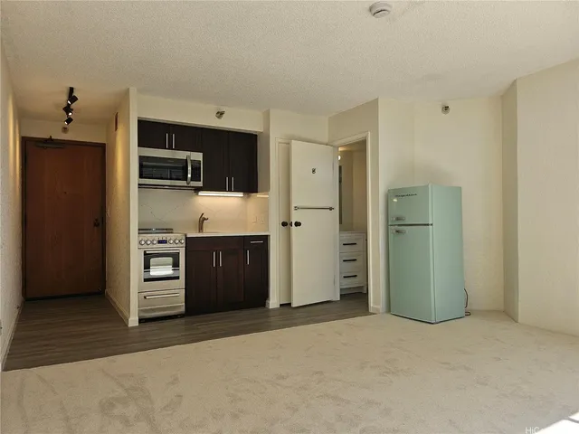 a view of a kitchen with refrigerator and cabinet