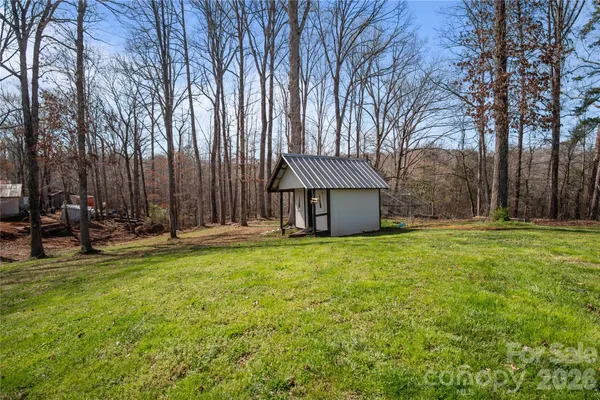a backyard of a house with barbeque oven