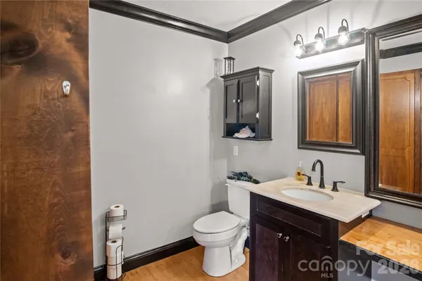 a bathroom with a toilet sink and mirror