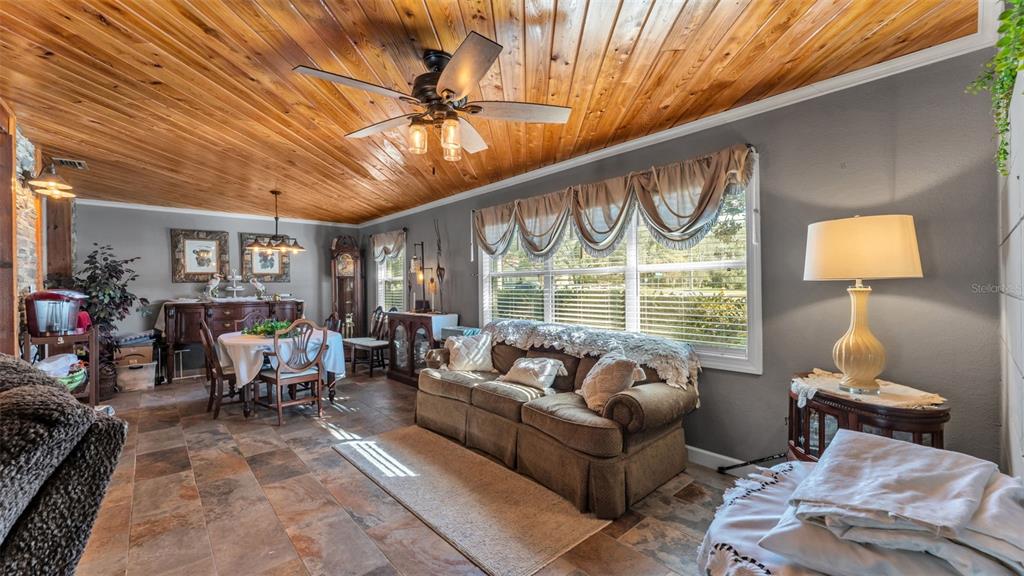 3830 Clubhouse Road Lakeland, FL 33812 - Photo 6 of 42 a living room with furniture a fireplace and a chandelier