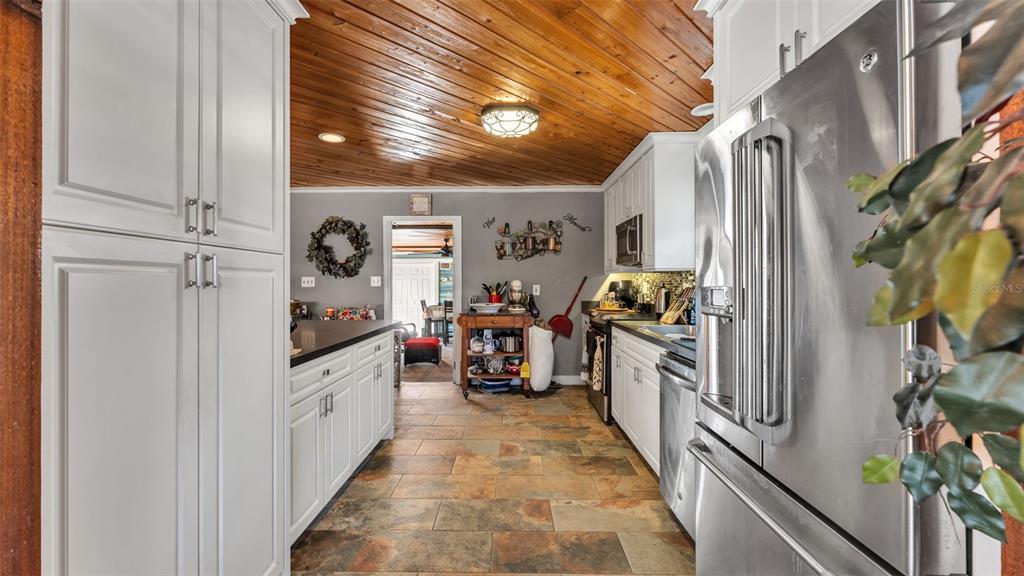 3830 Clubhouse Road Lakeland, FL 33812 - Photo 10 of 42 a kitchen with stainless steel appliances granite countertop a refrigerator and a sink
