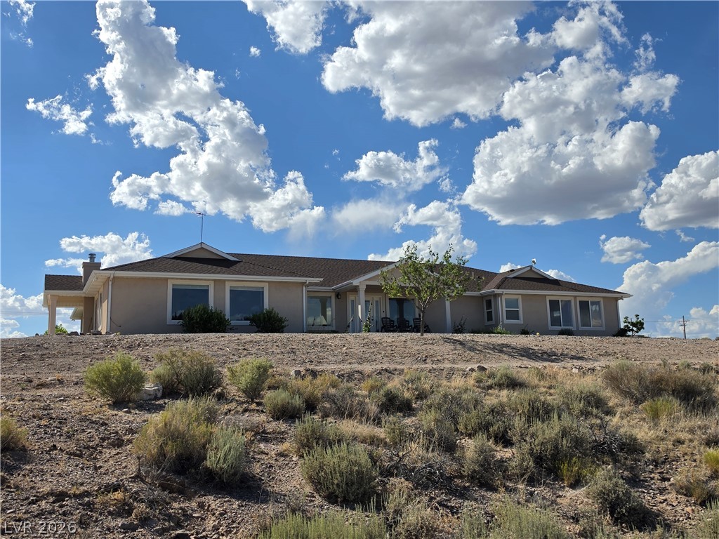 5272 Truman Lane Caliente, NV 89008 - Photo 1 of 43 Perched on a gentle rise, this home boasts broad windows and a serene natural setting.