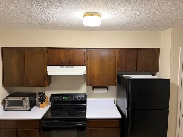 a kitchen with a stove and a refrigerator