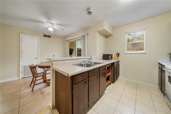 a kitchen that has a sink and a stove in it