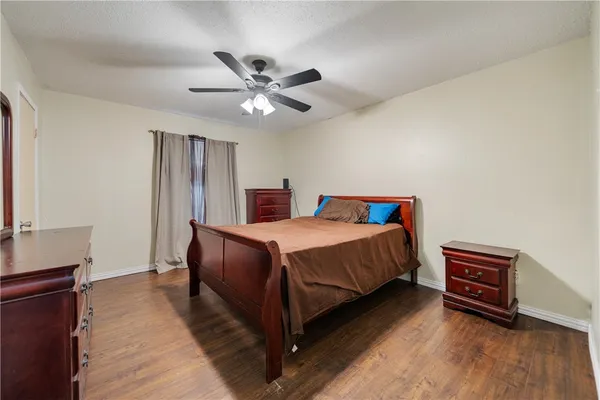 a bedroom with a large bed and a chandelier