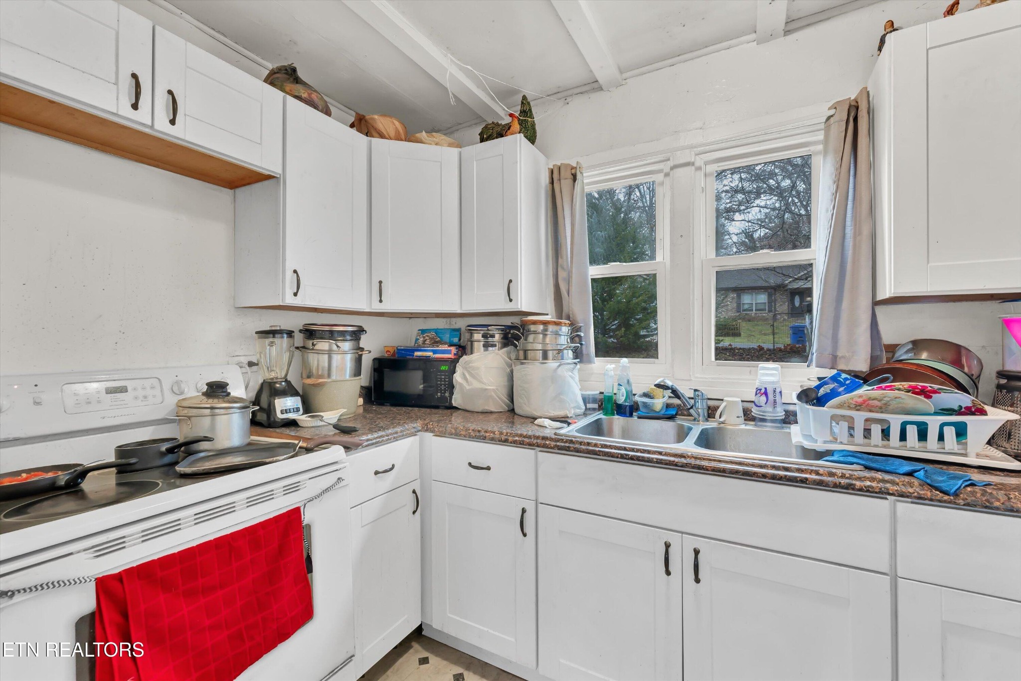 100102 Howard Lane Oak Ridge, TN 37830 - Photo 21 of 25 a kitchen with stainless steel appliances granite countertop a sink stove and cabinets