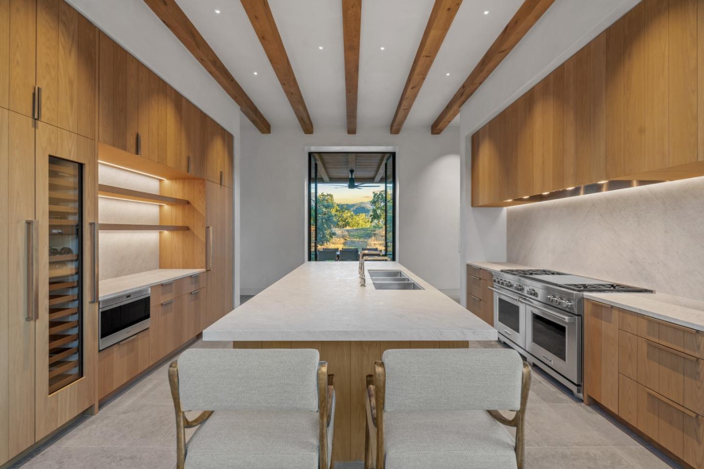 16 Touche Pass Carmel, CA 93923 - Photo 13 of 42 a kitchen with stainless steel appliances a stove a chimney a sink and cabinets