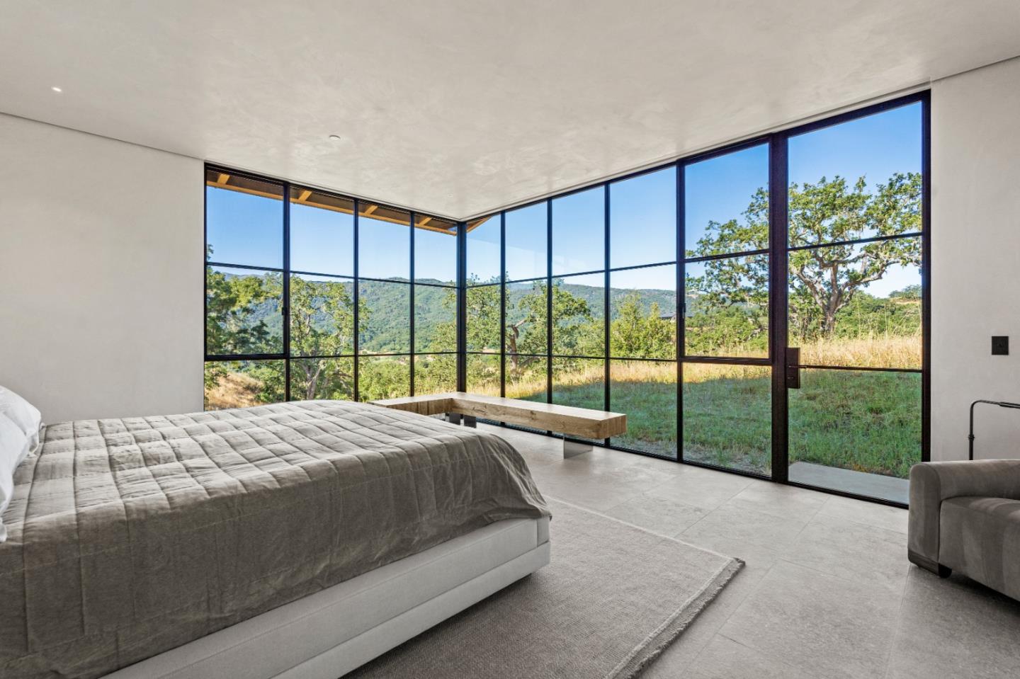 16 Touche Pass Carmel, CA 93923 - Photo 20 of 42 a bed sitting in a bedroom next to a large window