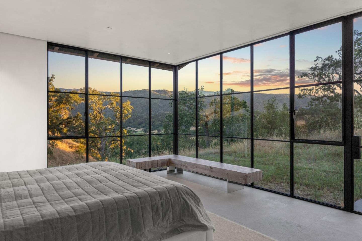 16 Touche Pass Carmel, CA 93923 - Photo 21 of 42 a bedroom with a large bed and a large window