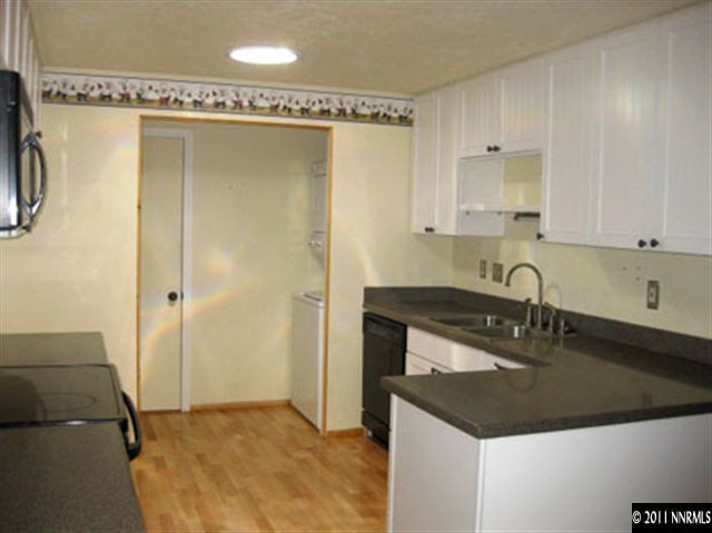 6905 Lotus Street Reno, NV 89506 - Photo 4 of 9 a kitchen with a sink and a refrigerator