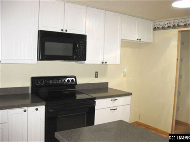 6905 Lotus Street Reno, NV 89506 - Photo 5 of 9 a kitchen with a sink stove and microwave