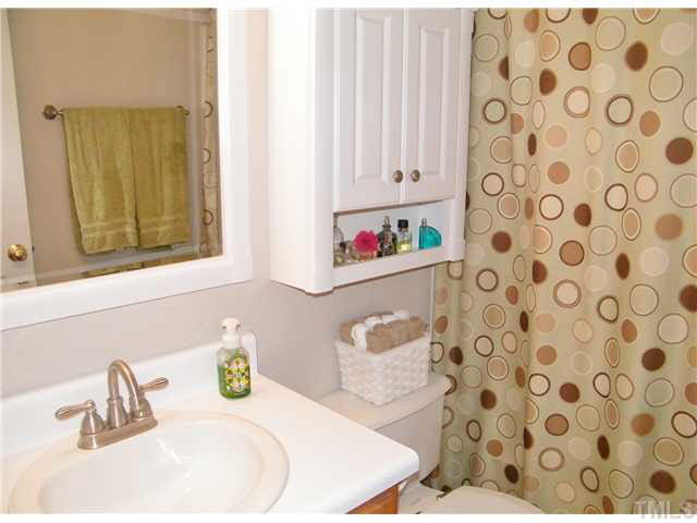 4925 Mocha Lane Raleigh, NC 27616 - Photo 12 of 25 a bathroom with a sink toilet and a mirror