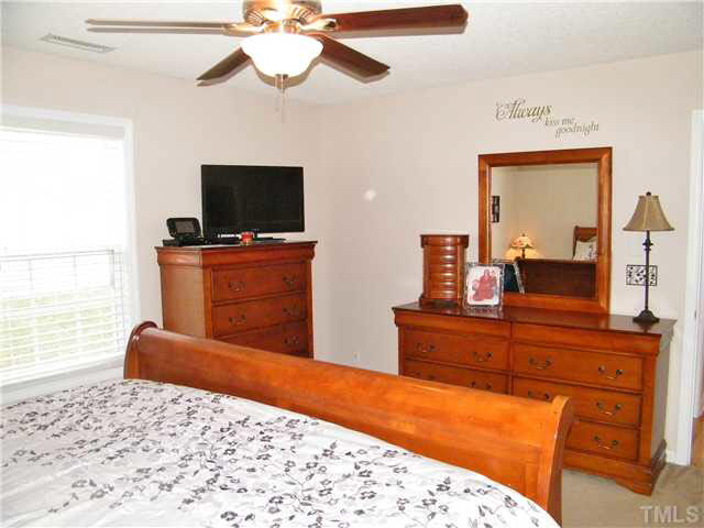 4925 Mocha Lane Raleigh, NC 27616 - Photo 13 of 25 a bedroom with a bed and flat screen tv