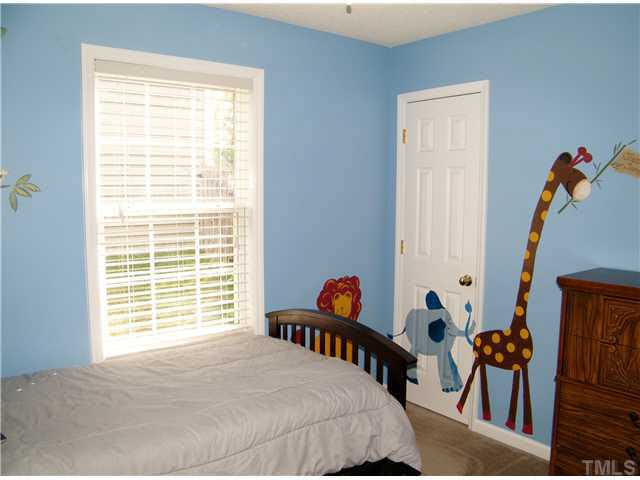 4925 Mocha Lane Raleigh, NC 27616 - Photo 17 of 25 a bedroom with furniture and a window