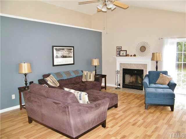 4925 Mocha Lane Raleigh, NC 27616 - Photo 4 of 25 a living room with furniture and a fireplace