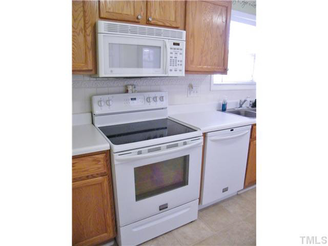 4925 Mocha Lane Raleigh, NC 27616 - Photo 8 of 25 a kitchen with a stove and a microwave