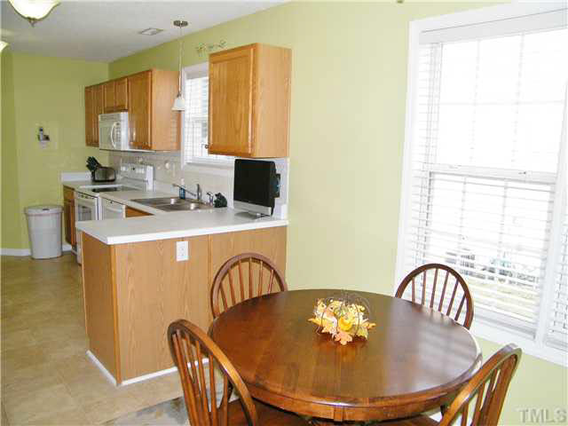 4925 Mocha Lane Raleigh, NC 27616 - Photo 10 of 25 a view of a dining room with furniture window and wooden floor
