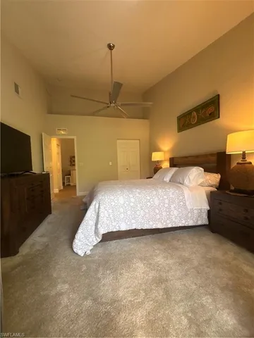 a bedroom with a bed and flat screen tv