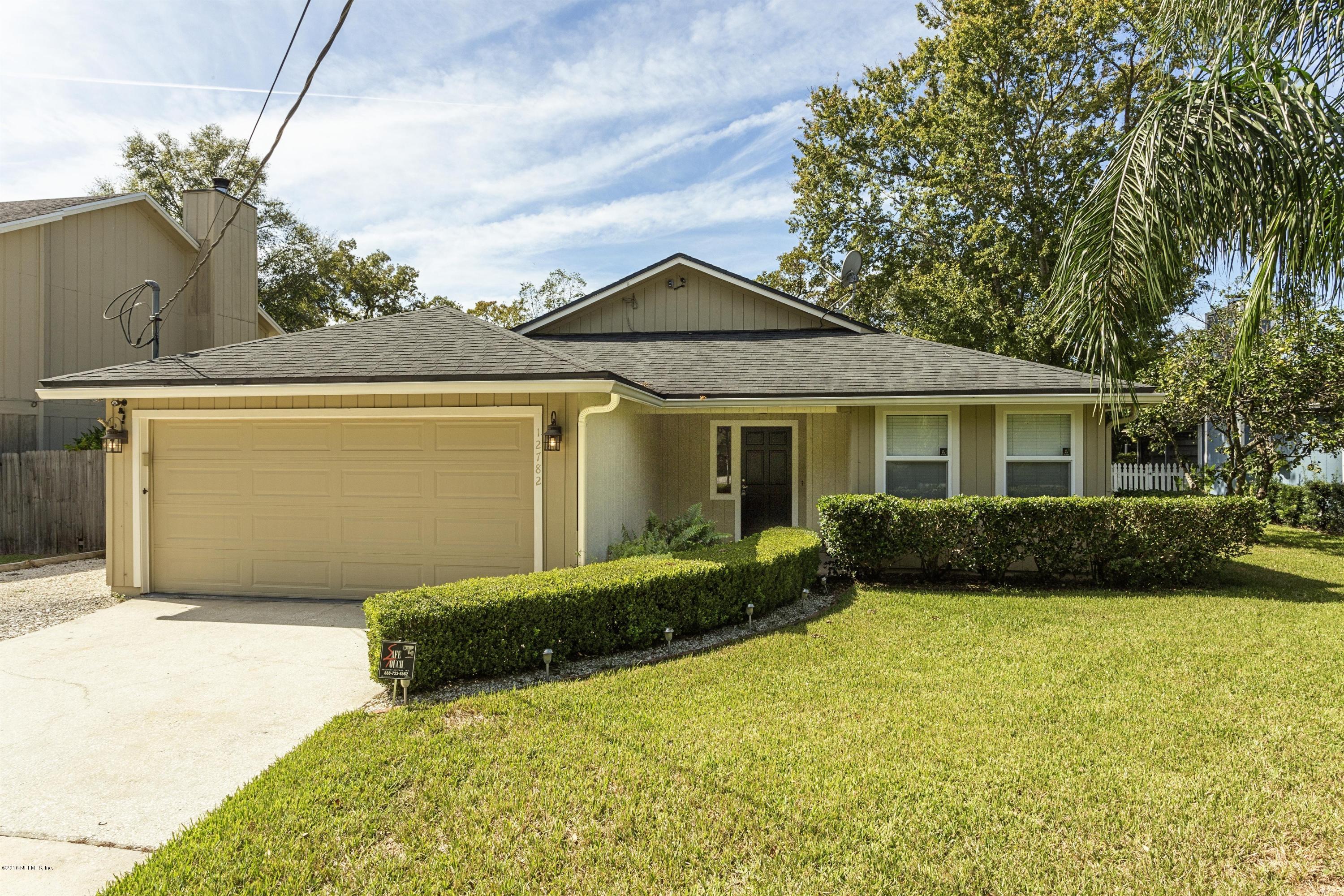12782 Attrill Road Jacksonville, FL 32258 - Photo 1 of 25 a front view of a house with garden