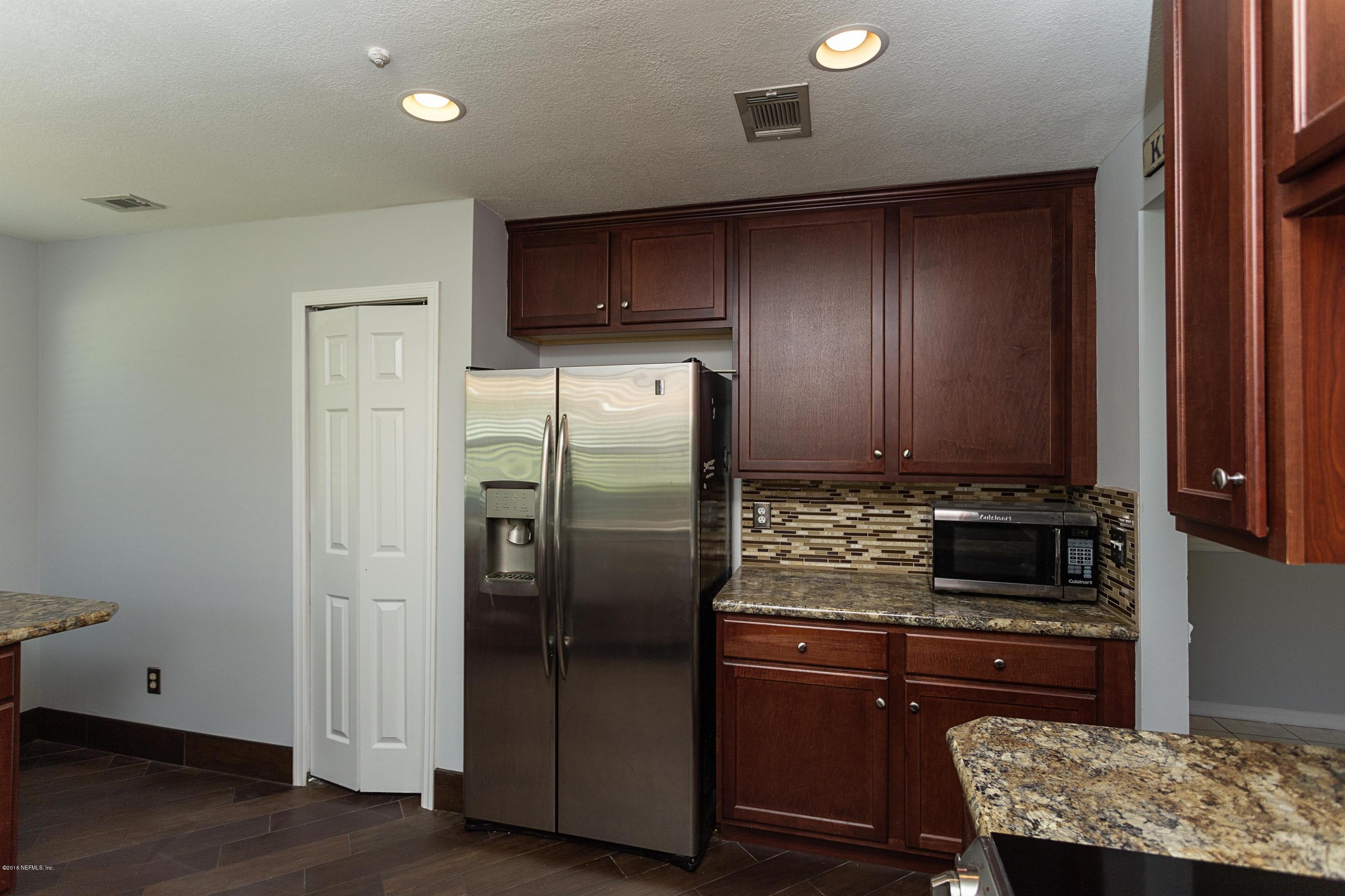 12782 Attrill Road Jacksonville, FL 32258 - Photo 11 of 25 a kitchen with stainless steel appliances granite countertop a refrigerator and a stove