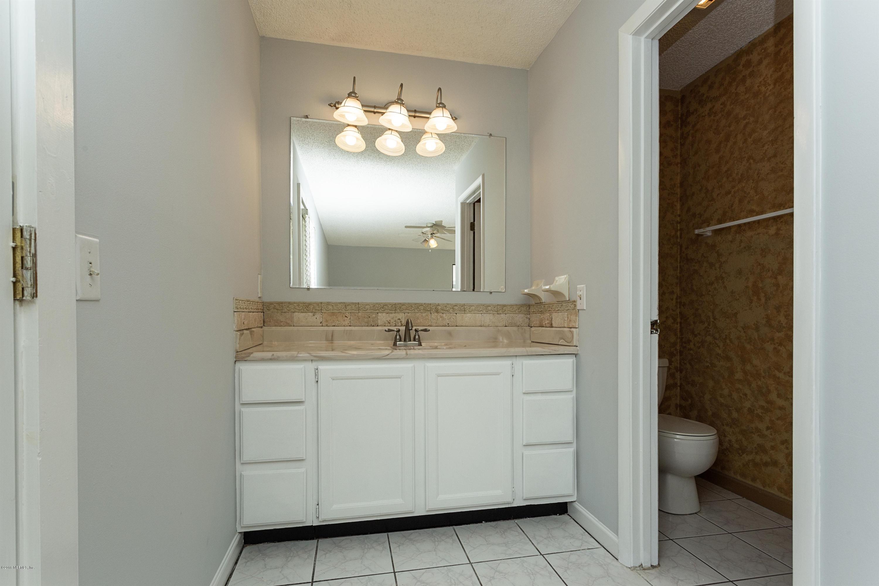 12782 Attrill Road Jacksonville, FL 32258 - Photo 15 of 25 a bathroom with a toilet sink and mirror