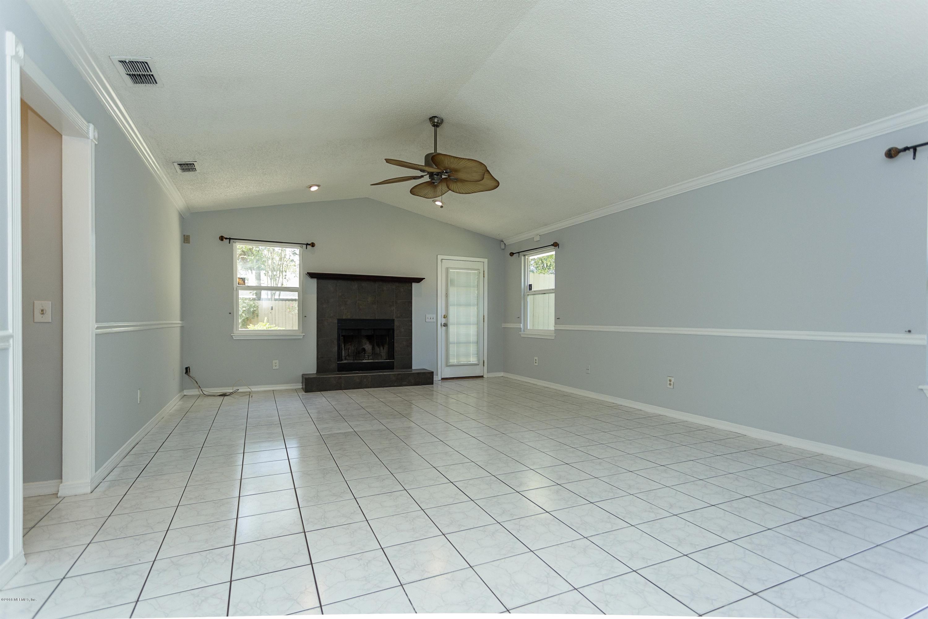 12782 Attrill Road Jacksonville, FL 32258 - Photo 4 of 25 an empty room with windows and fireplace