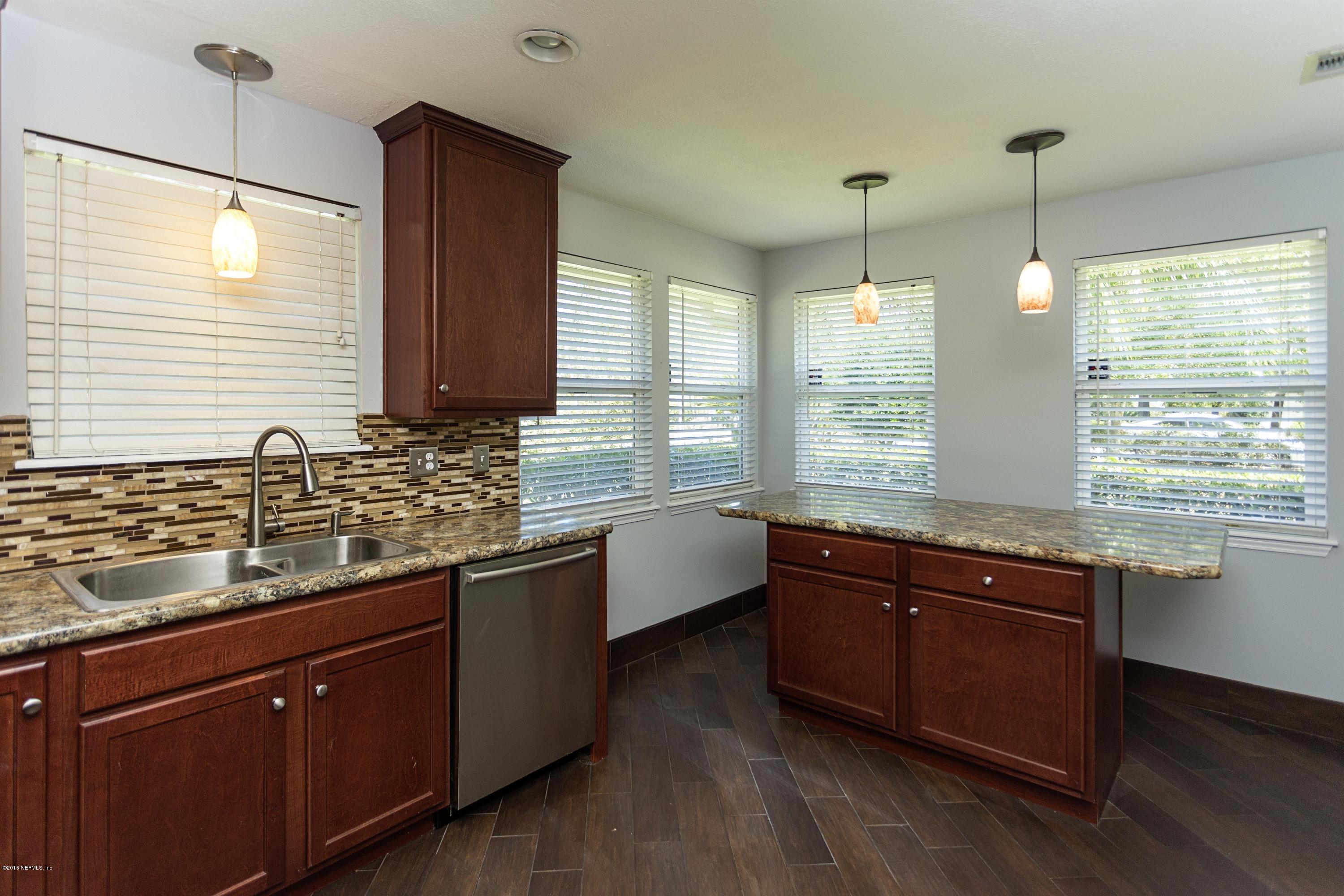 12782 Attrill Road Jacksonville, FL 32258 - Photo 8 of 25 a large kitchen with kitchen island granite countertop a sink and wooden floor