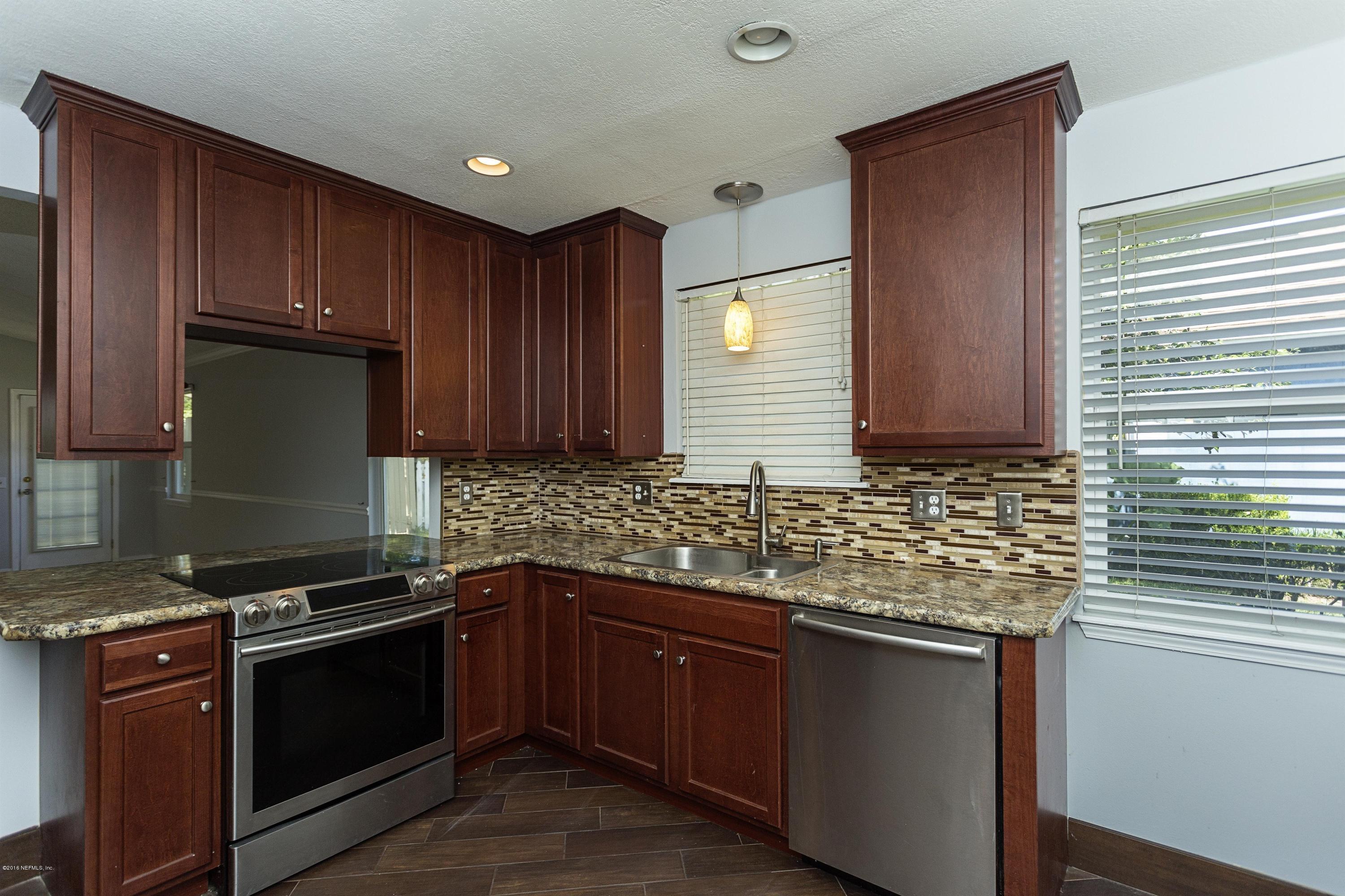 12782 Attrill Road Jacksonville, FL 32258 - Photo 10 of 25 a kitchen with stainless steel appliances granite countertop wooden cabinets a stove top oven a sink and dishwasher