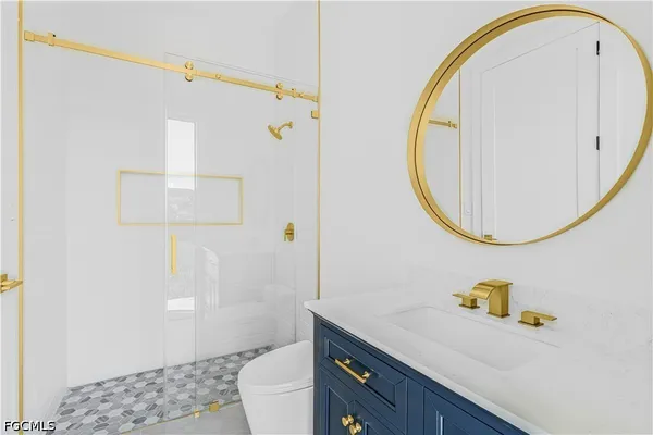 a bathroom with a sink a toilet and a mirror
