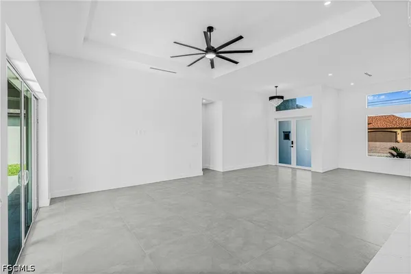 an empty room with closet and windows