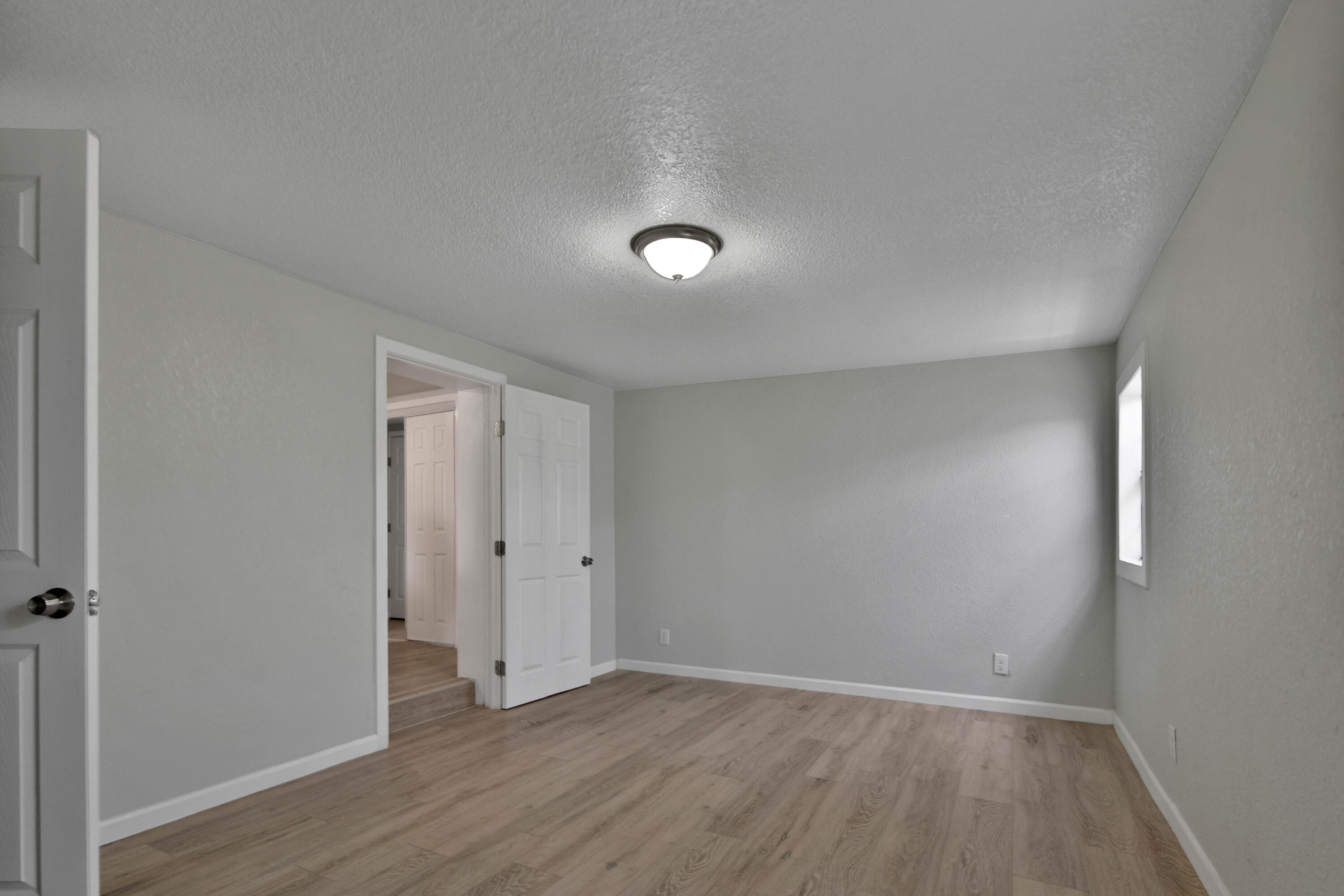 312 North Avenue R Lubbock, TX 79415 - Photo 12 of 26 a view of an empty room with wooden floor