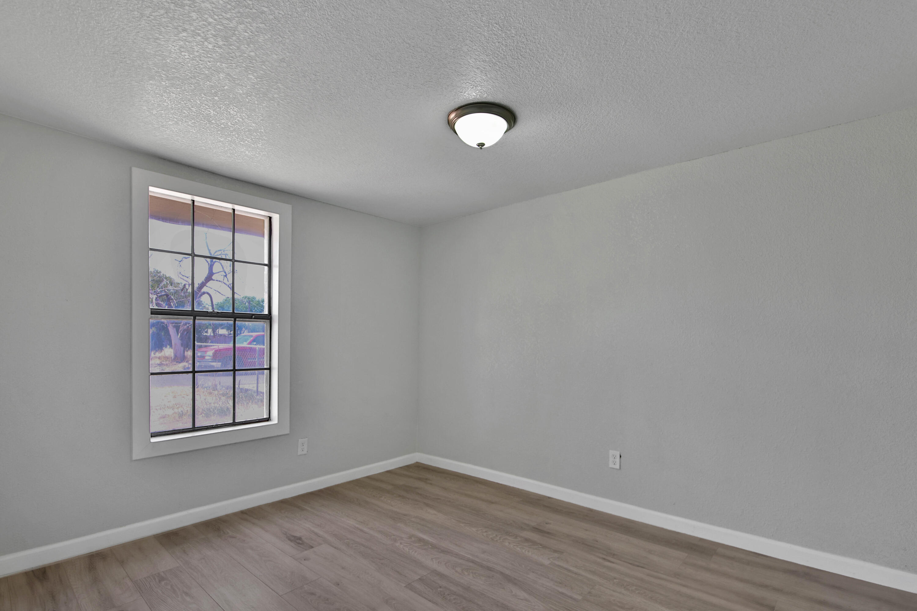 312 North Avenue R Lubbock, TX 79415 - Photo 15 of 26 an empty room with wooden floor and windows