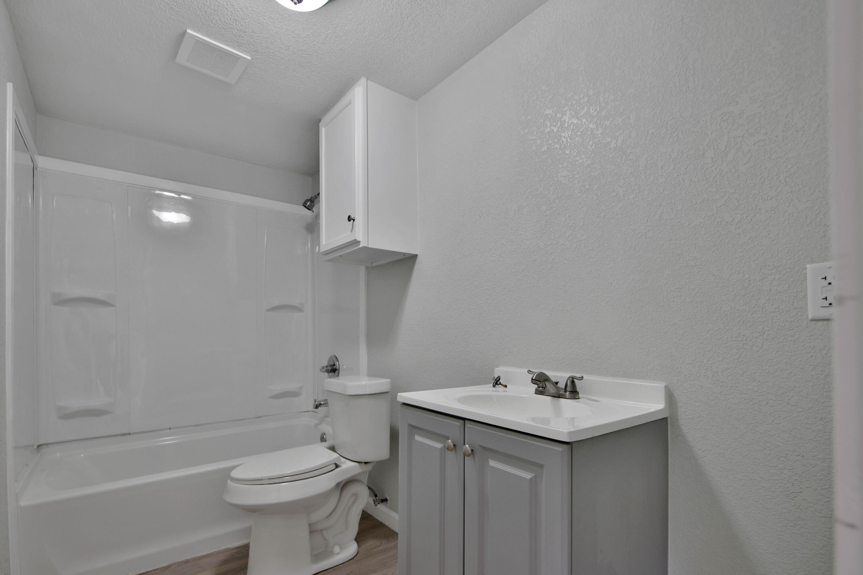 312 North Avenue R Lubbock, TX 79415 - Photo 19 of 26 a bathroom with a granite countertop sink toilet and shower