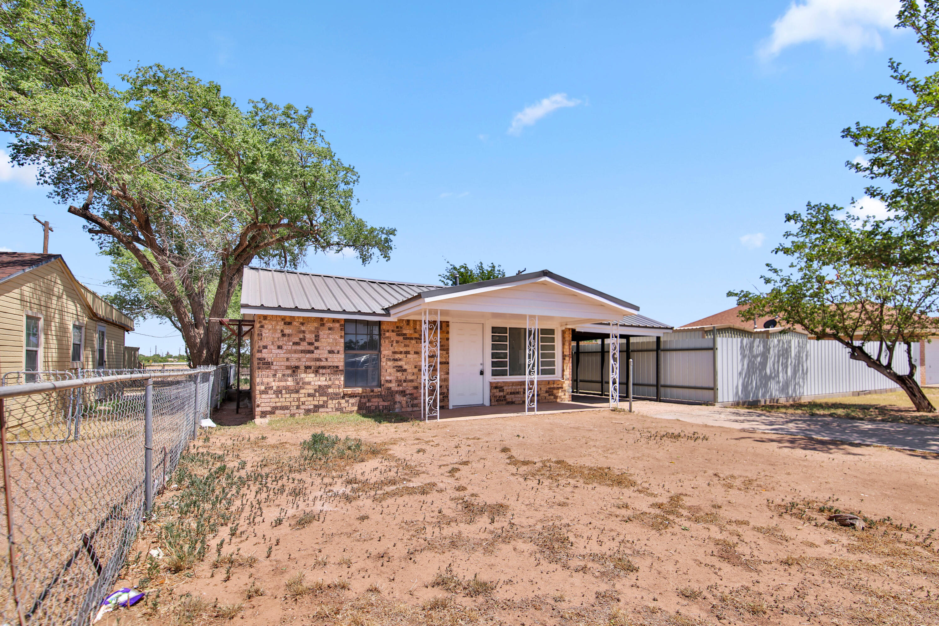 312 North Avenue R Lubbock, TX 79415 - Photo 2 of 26 a view of a house with a yard covered in snow