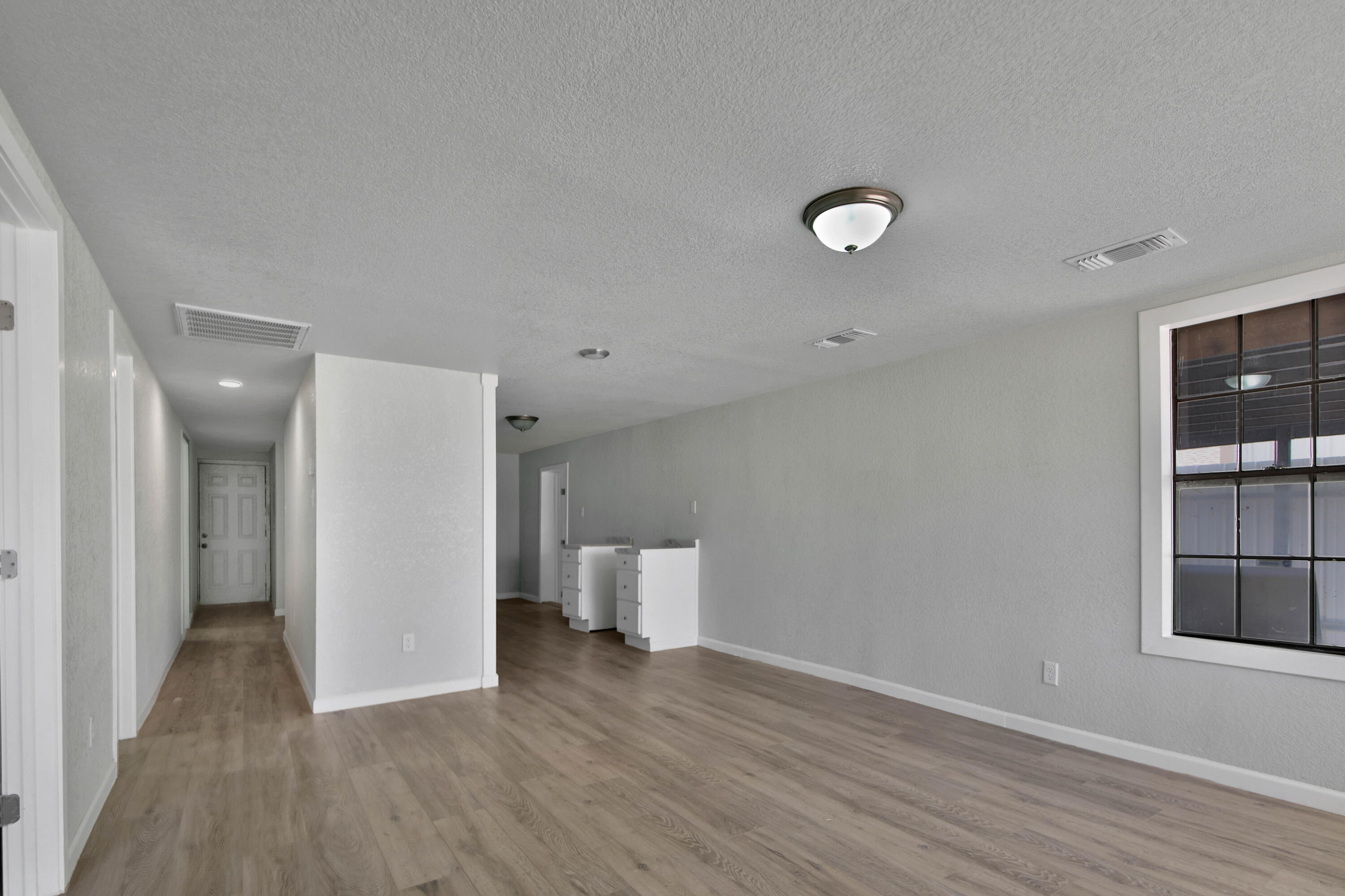 312 North Avenue R Lubbock, TX 79415 - Photo 4 of 26 wooden floor in an empty room with a window
