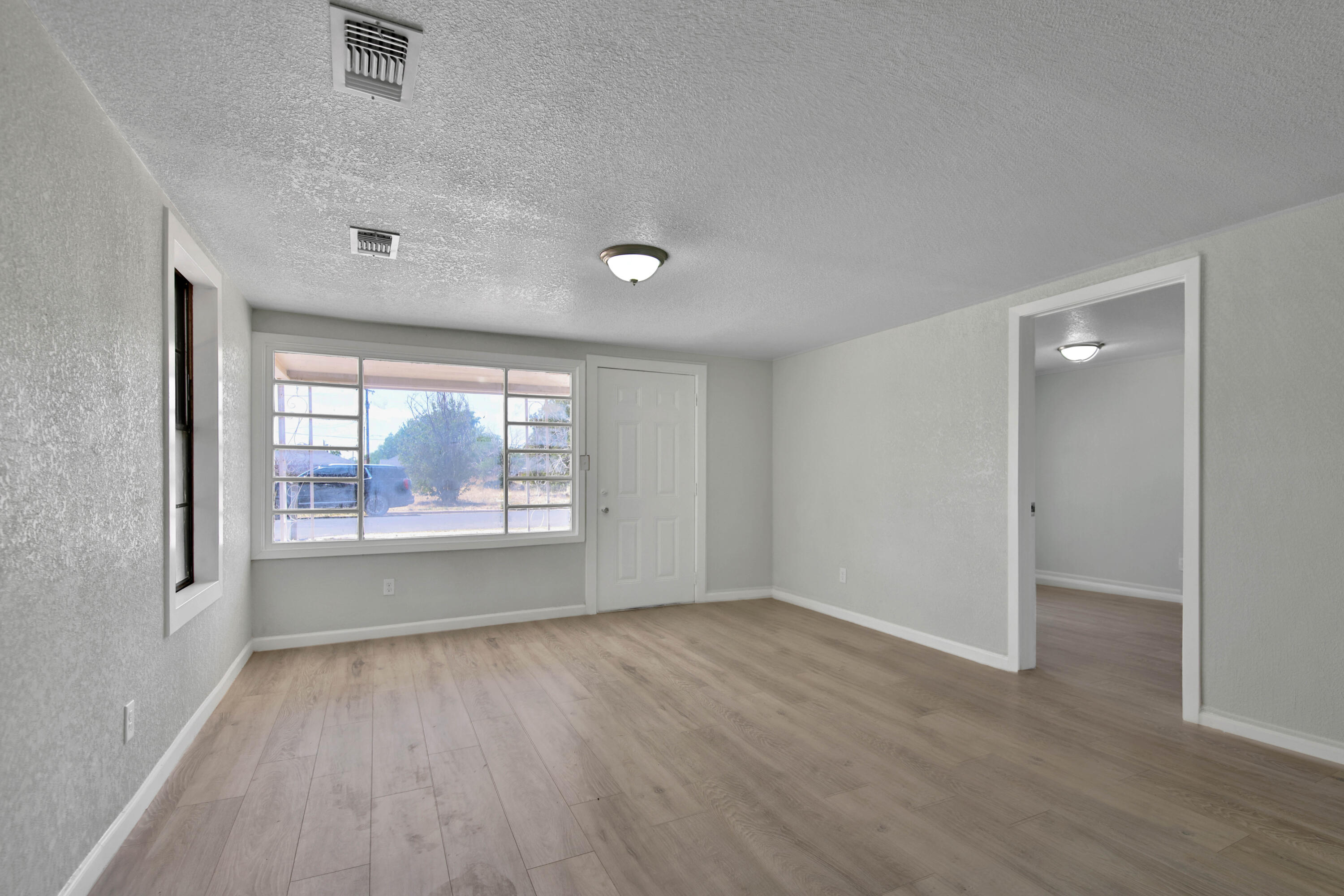 312 North Avenue R Lubbock, TX 79415 - Photo 5 of 26 wooden floor in an empty room with a window