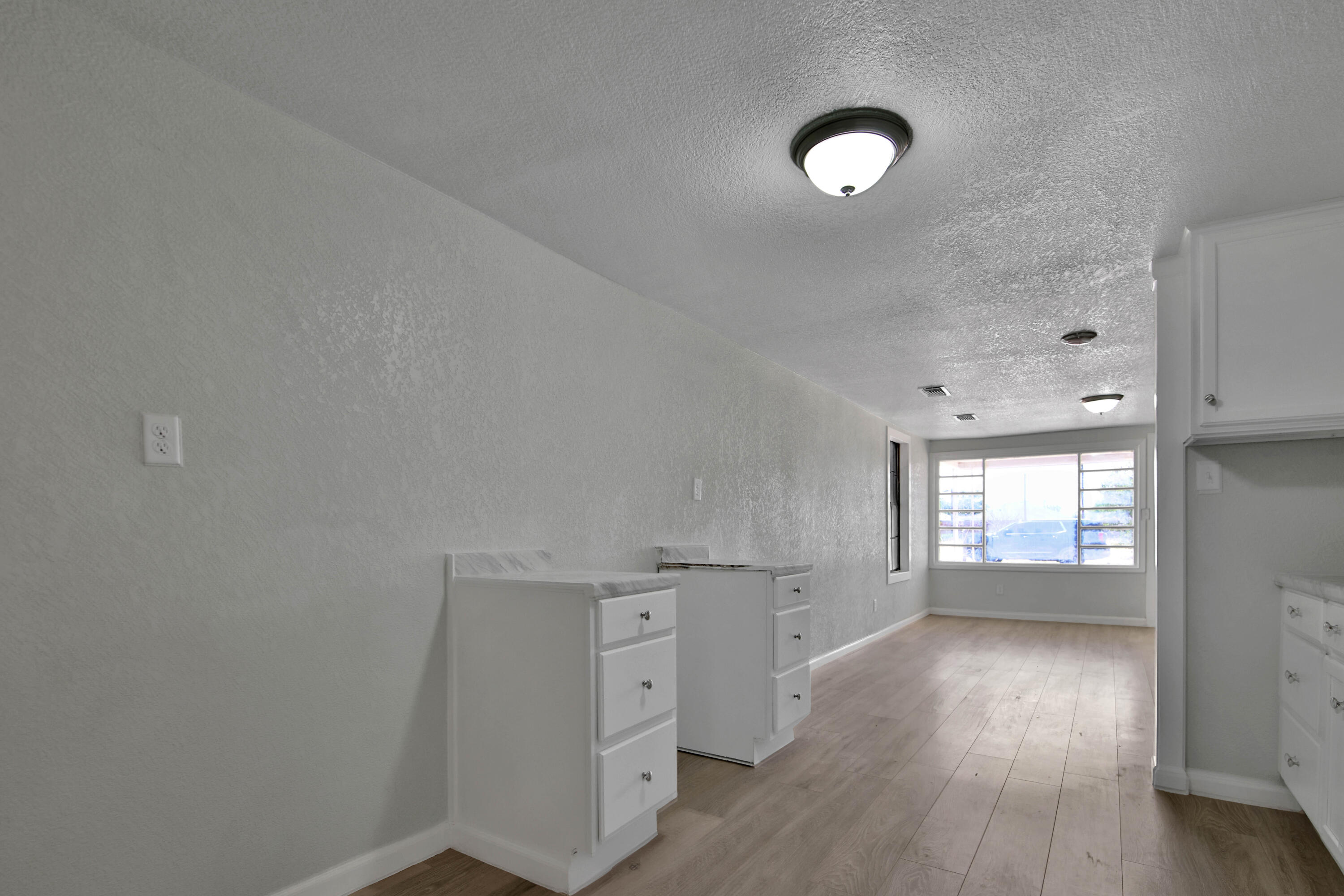 312 North Avenue R Lubbock, TX 79415 - Photo 8 of 26 an empty room with wooden floor and windows
