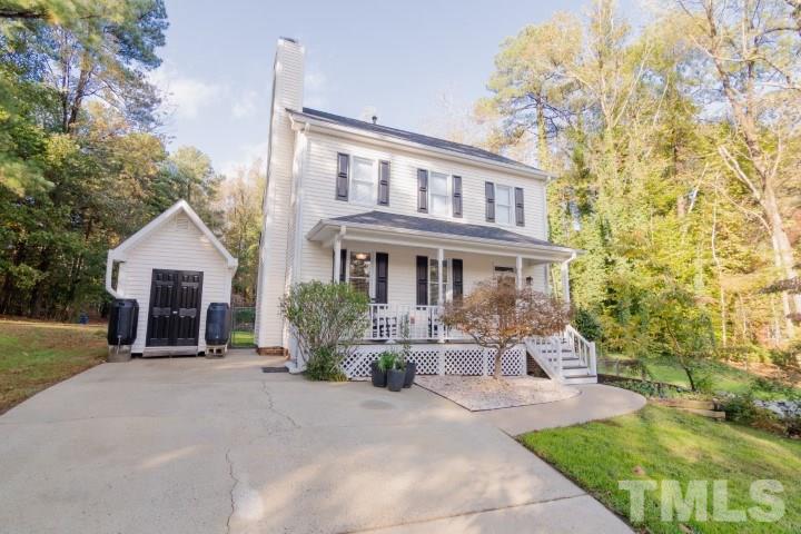 6940 Spring Drive Raleigh, NC 27613 - Photo 1 of 18 a front view of a house with a yard and potted plants